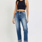 Model wearing RISEN Full Size High Rise Crop Straight Roll Up Jeans with a black crop top and stylish heels.