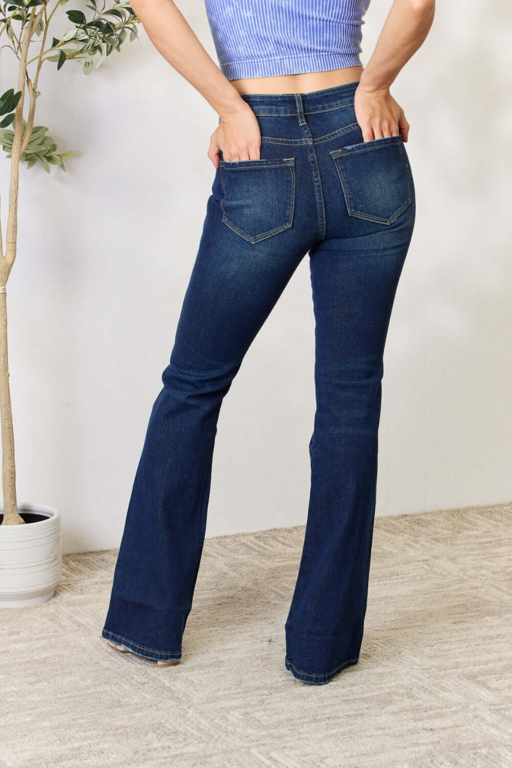 Back view of woman wearing slim bootcut jeans, showing off the flattering fit and flared legs, perfect for any occasion.