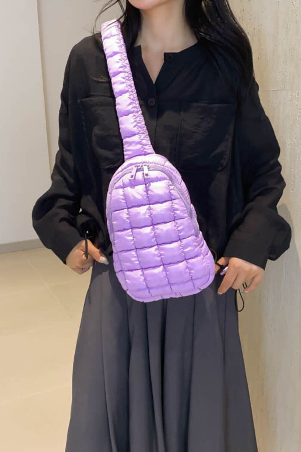 Stylish lavender Bella Road Quilted Nylon Crossbody Bag worn with a black shirt and gray skirt, perfect for trendy fashion lovers.