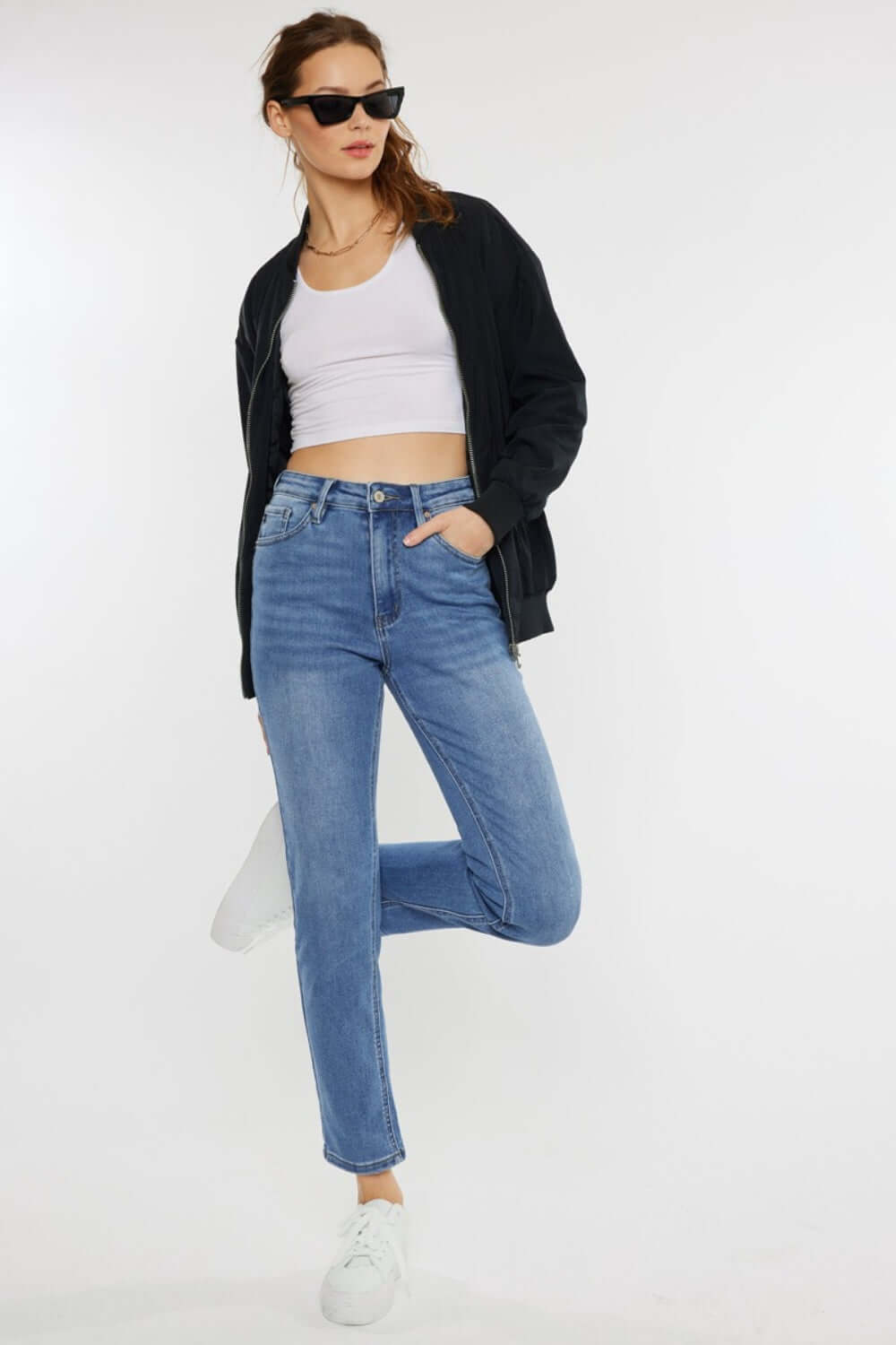 Model wearing Cat's Whiskers High Waist Jeans with a casual white tank top and black jacket, showcasing a stylish, vintage-inspired look.