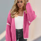 Trendy pink open front dropped shoulder cardigan with white trim for a chic look