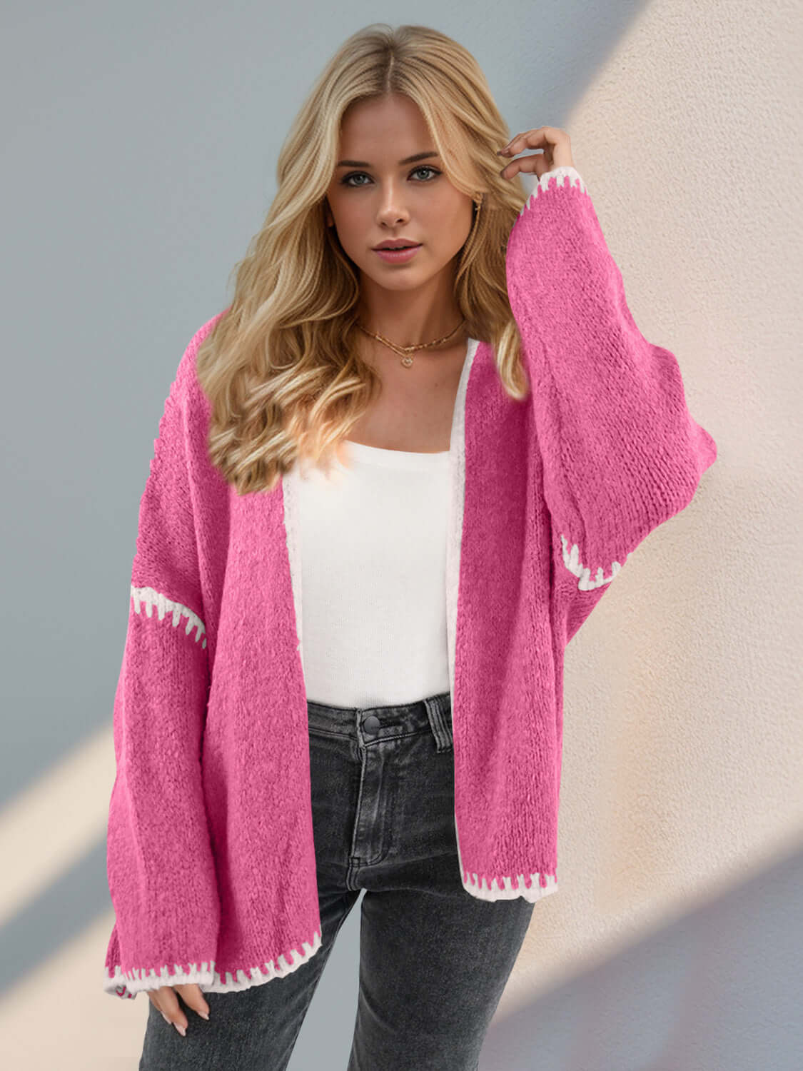 Trendy pink open front dropped shoulder cardigan with white trim for a chic look