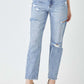 Stylish distressed slim cropped Risen Jeans with edgy detailing, perfect for a trendy and chic look, paired with beige heels.