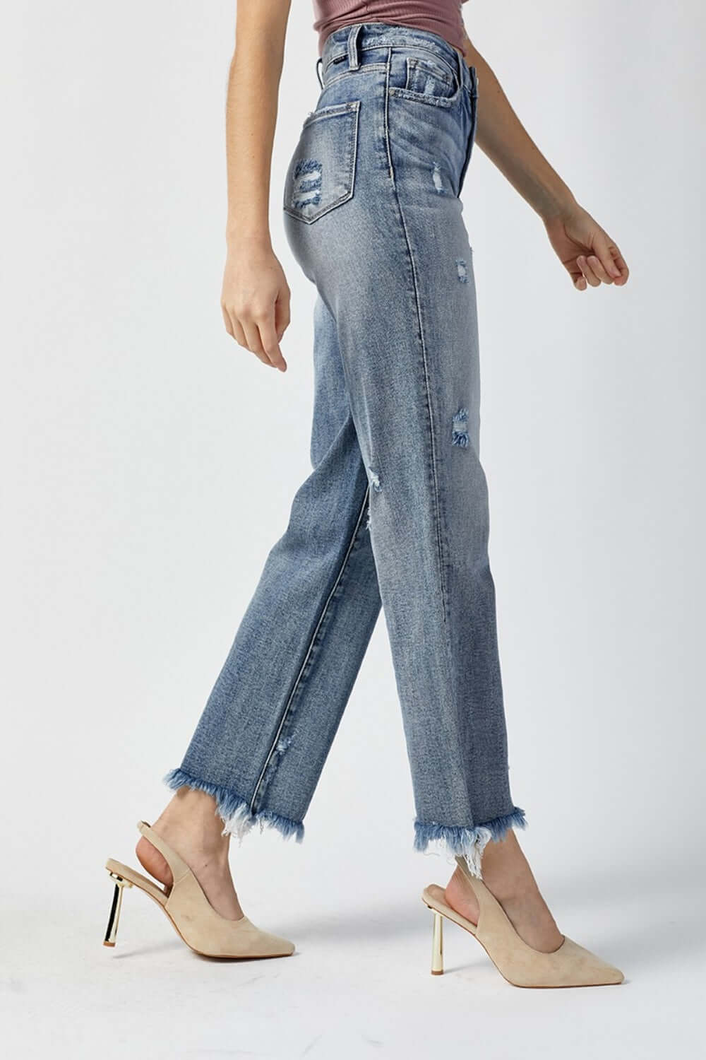 Woman wearing High Waist Raw Hem Straight Jeans by Risen Jeans with chic high-rise waist and casual raw hem detailing.