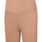 Millennia Seamless High-Rise Wide Waistband Biker Shorts in a warm tan color for stylish comfort and flexibility.