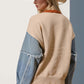 Woman wearing raw edge sweater with star pattern, beige and denim sleeves, paired with frayed shorts and cowboy hat. Casual chic style.