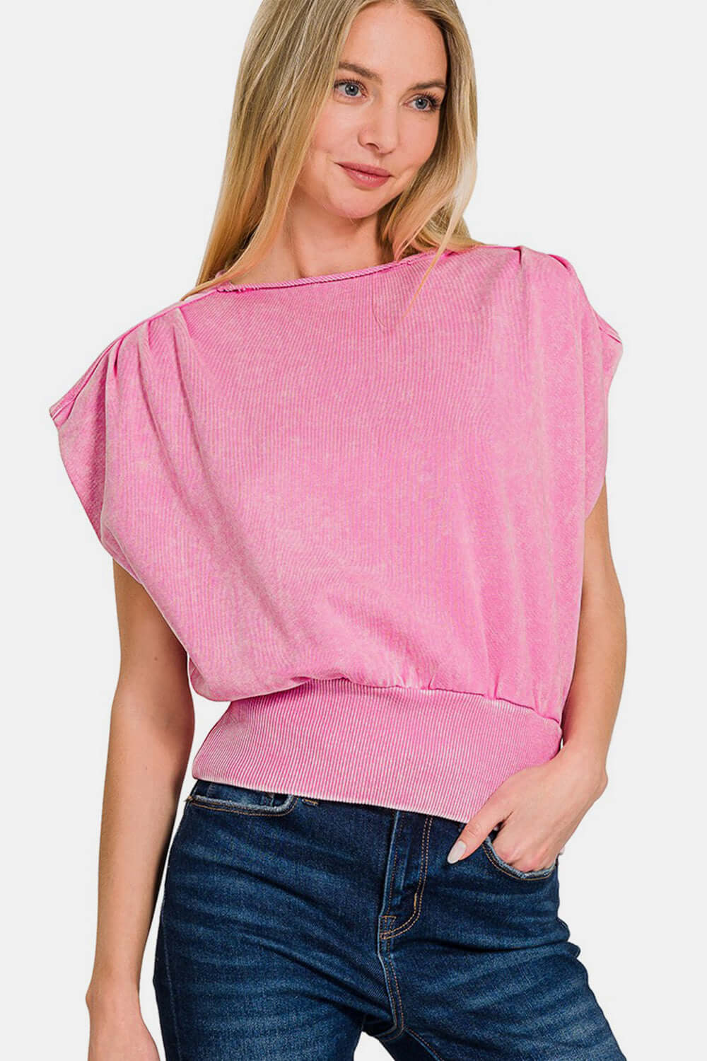 Woman wearing washed boat neck bottom banded dolman sleeve top in pink, showcasing casual chic style with vintage-inspired look.