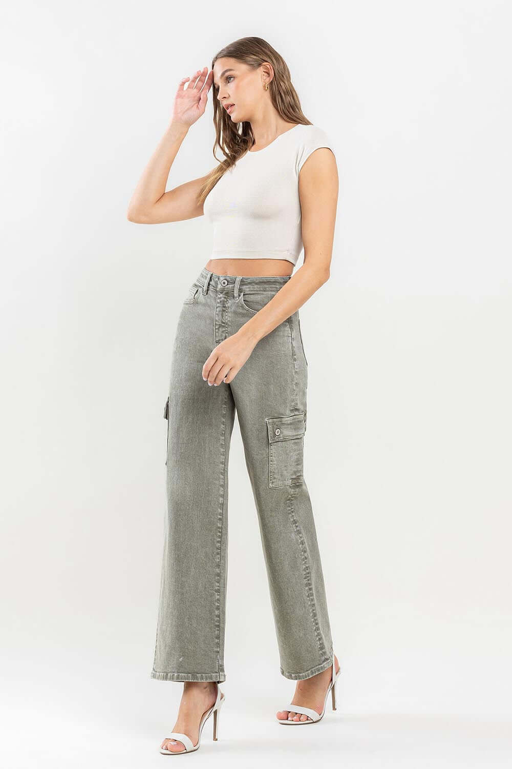 Model wearing '90s Super High Rise Loose Cargo Jeans with ultra-high waist and cargo pockets paired with a white crop top and heels.