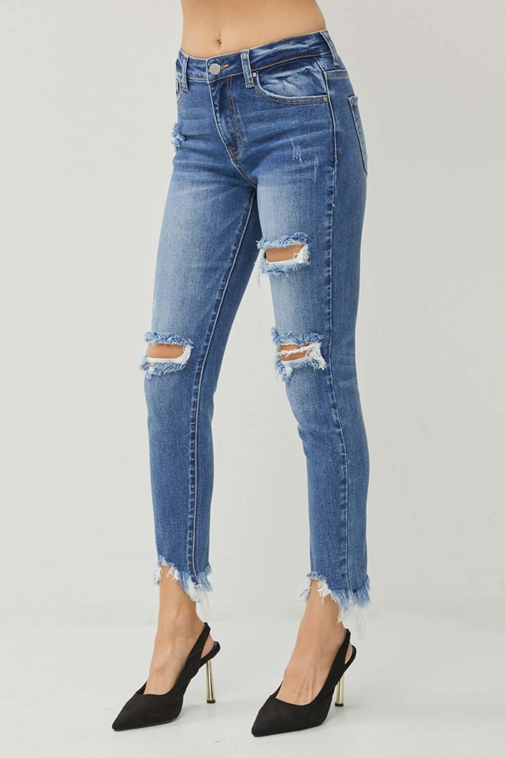 Distressed Frayed Hem Slim Jeans by Risen Jeans, showcasing edgy distressed details, slim fit design, and rugged frayed hem for a trendy look.