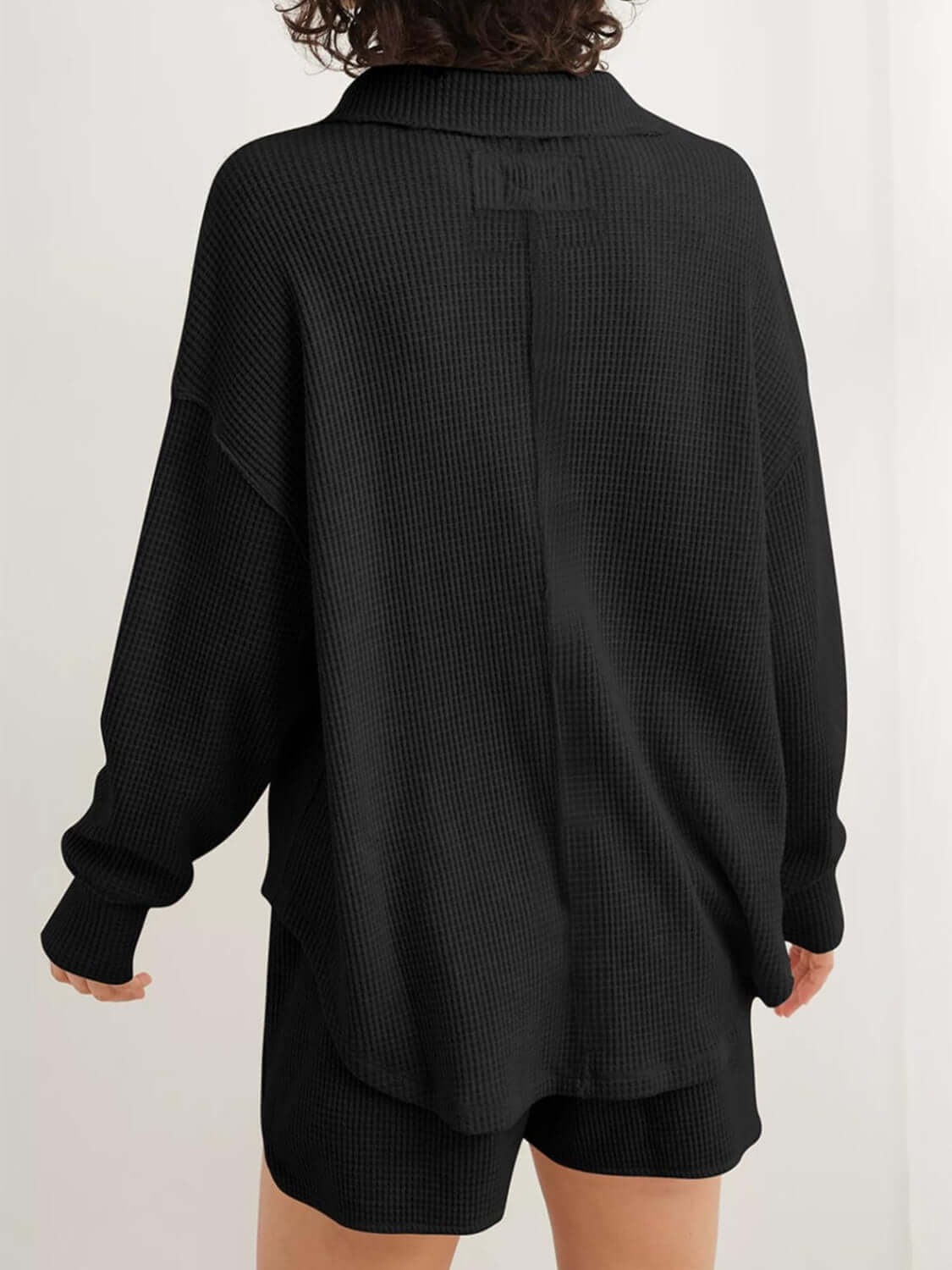 Back view of black waffle-knit long sleeve sweatshirt with Johnny collar, slightly stretchy cotton-polyester blend, machine washable