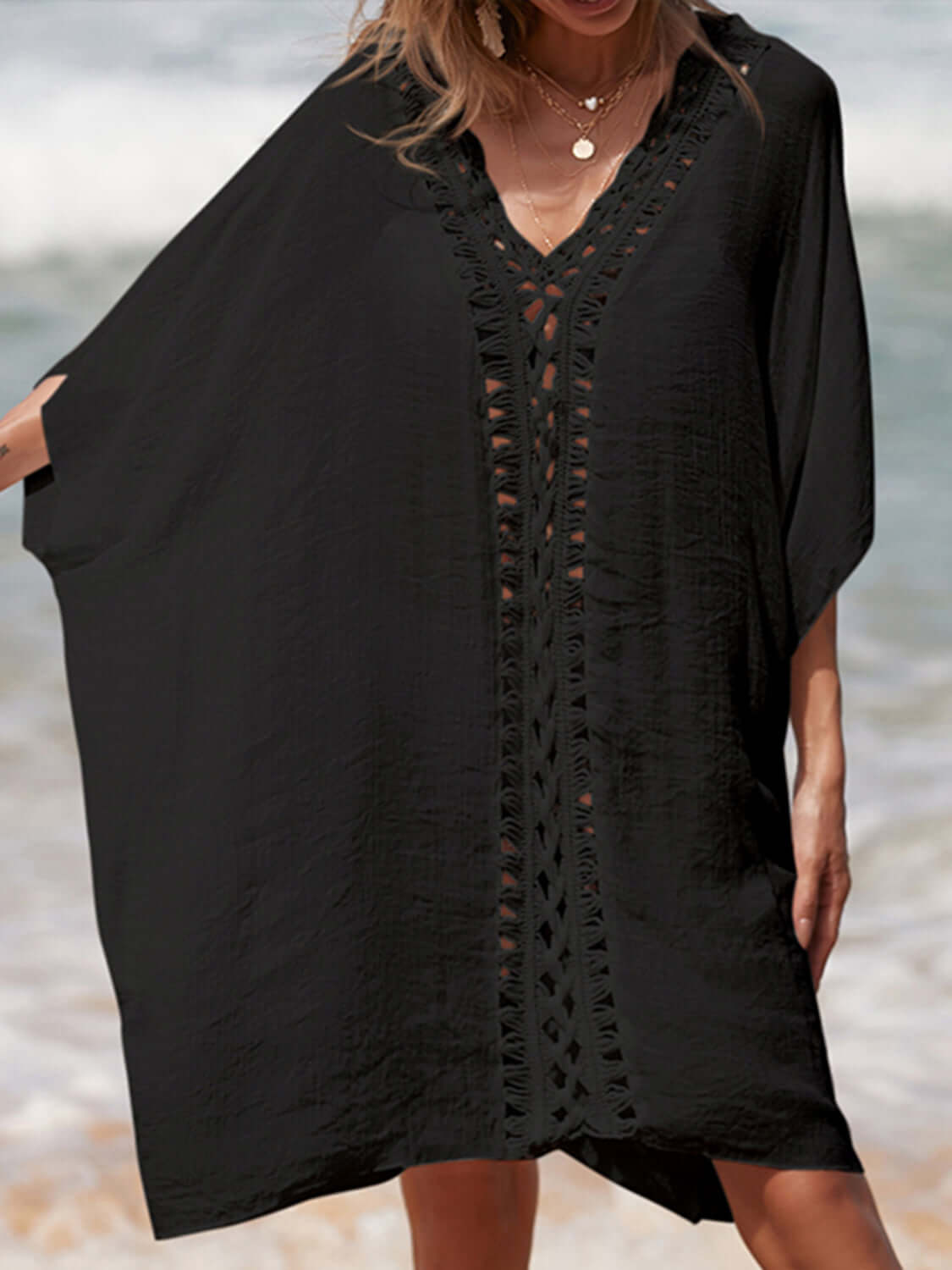 Cutout V-Neck three-quarter sleeve sheer cover-up with openwork design in black, perfect for beachwear. Made of 65% cotton, 35% polyester