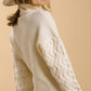 Cozy cream turtle neck long sleeve sweater with cable knit sleeves, perfect for winter styling in plus sizes.