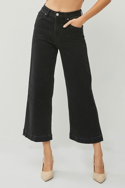 Model showcasing RISEN Full Size High Rise Wide Leg Ankle Jeans in black, styled with heels for a chic look.