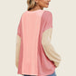 Woman wearing pink and beige Double Take Texture Contrast Round Neck Long Sleeve T-Shirt with jeans, viewed from the back