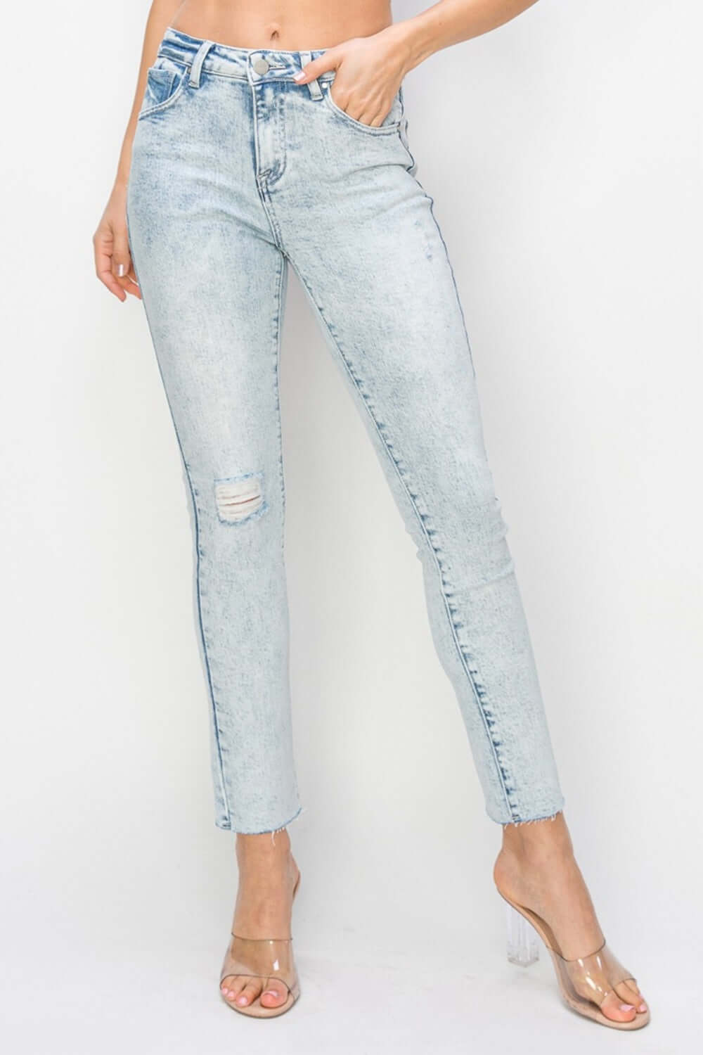 High rise distressed skinny jeans with a figure-flattering silhouette by Risen Jeans, featuring trendy distressed details.