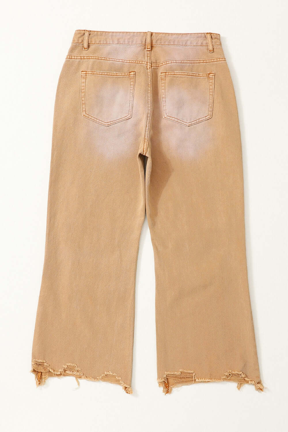 Tan distressed raw hem jeans with pockets viewed from the back