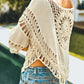 Stylish cream crochet cover up with fringe, perfect for summer days at the beach or pool.