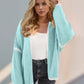 Woman wearing a Tiffany Blue open front dropped shoulder cardigan with a relaxed fit.