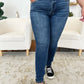 Woman wearing Classic Handsand Skinny Jeans by Judy Blue, showcasing a trendy, hand-sanded finish with a flattering skinny fit.