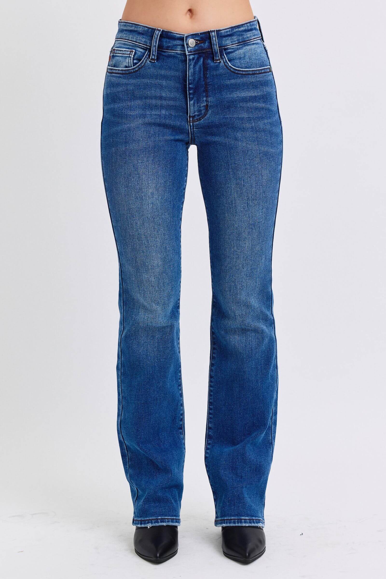 Judy Blue mid-rise bootcut jeans with thermal lining, showcasing a classic silhouette and flattering fit for all body types.