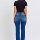 Woman wearing Judy Blue mid-rise bootcut jeans with thermal lining, shot from the back, showcasing a flattering silhouette.