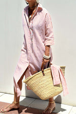 Woman wearing a Bella Road Tied Button Up Three-Quarter Sleeve Dress, holding a straw tote bag, and enjoying a sunny day outdoors.