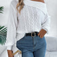 Woman wearing Bella Road Cable-Knit One Shoulder Long Sleeve Sweater in white, paired with jeans and holding a handbag