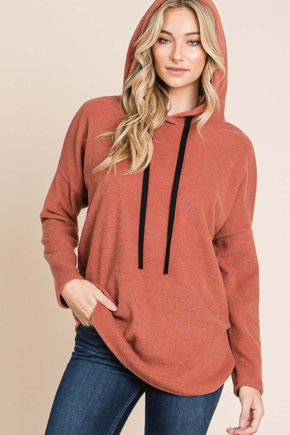 Woman models BOMBOM Contrast Drawstring Drop Shoulder Knit Hoodie, showcasing its cozy relaxed fit and stylish design.