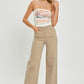 Woman wearing RISEN full size tummy control high rise wide leg jeans, styled effortlessly for a trendy look.