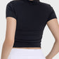 Woman wearing a black Millennia Ruched Round Neck Short Sleeve Active T-Shirt, showcasing the stylish ruched back design.