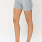 Woman wearing color block denim shorts by Judy Blue Jeans for a trendy summer look