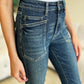 Close-up of woman wearing High Waist Skinny Jeans by Judy Blue with her hand resting on the pocket