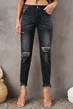 Stylish Distressed Cropped Jeans with Slight Stretch in Black, Featuring Ripped Knees and Raw Hem, Perfect for Casual Wear.