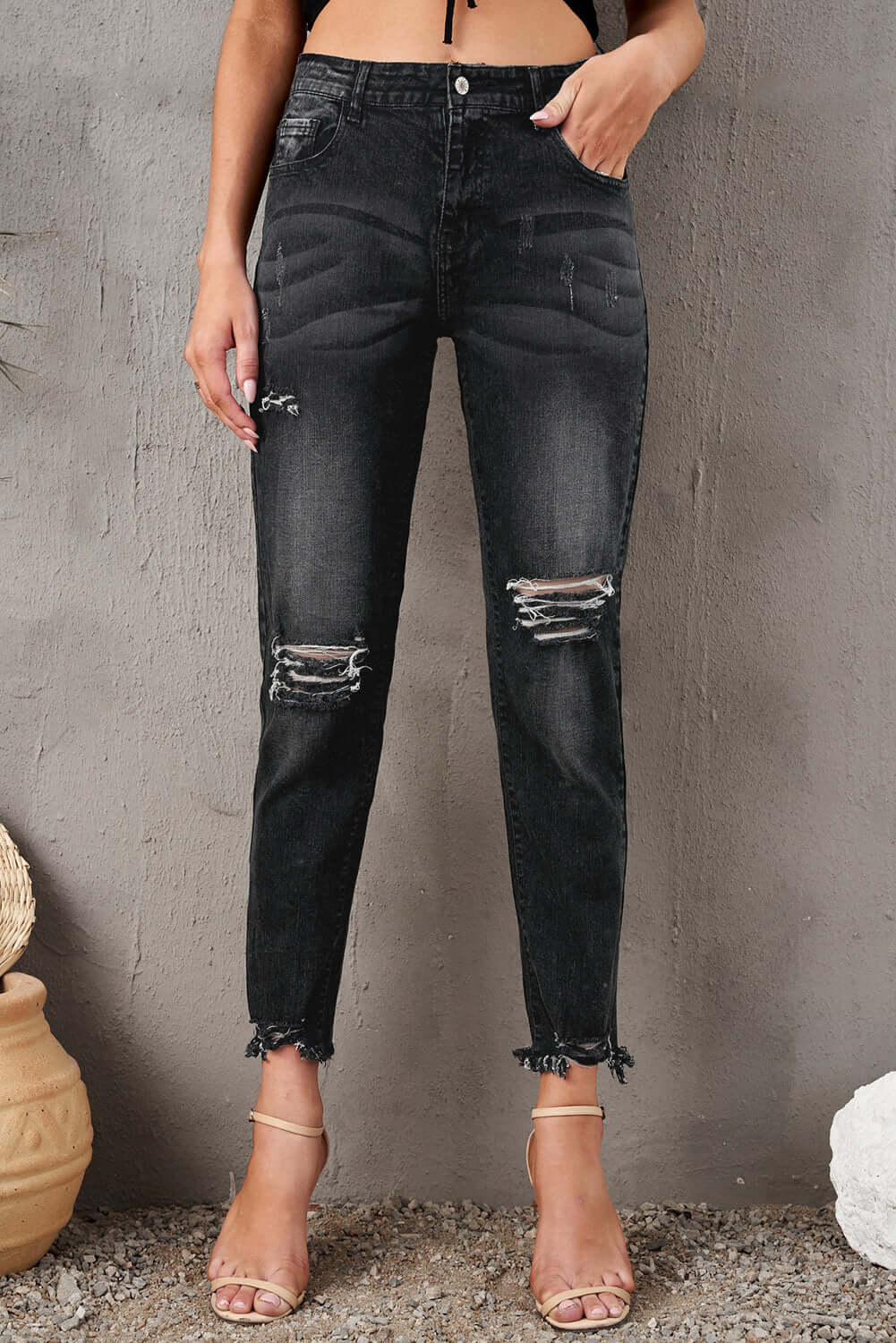 Stylish Distressed Cropped Jeans with Slight Stretch in Black, Featuring Ripped Knees and Raw Hem, Perfect for Casual Wear.