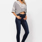 Woman wearing Judy Blue High Waist Handsand Skinny Jeans with a striped top and sandals against a white background