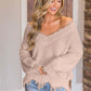 Woman wearing Bella Road Frayed Hem Dropped Shoulder Sweater in beige, showcasing its playful and stylish design.