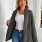 Woman wearing Ivy Lane Zip Up Long Sleeve Fuzzy Jacket in monochrome, showing cozy style and pockets. Perfect for chilly days.