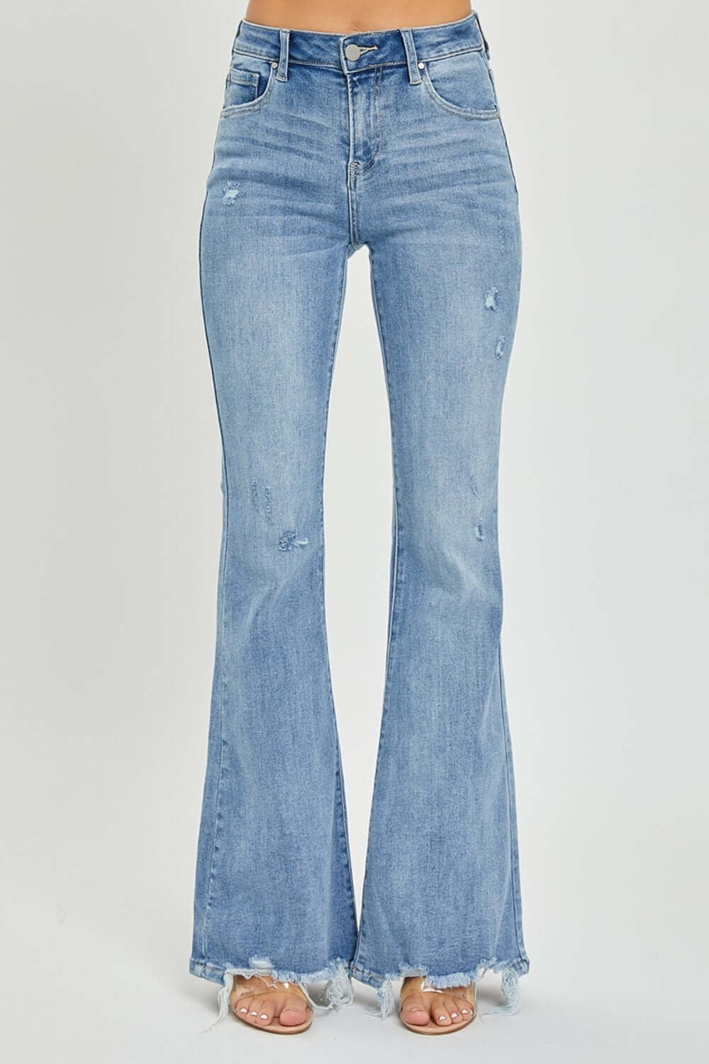 Trendy high-rise frayed hem flare jeans by Risen Jeans, featuring a fashionable retro-inspired silhouette for a chic and casual look.