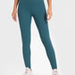 Woman in teal Millennia yoga leggings with wide waistband, showcasing comfort and flexibility for workouts.