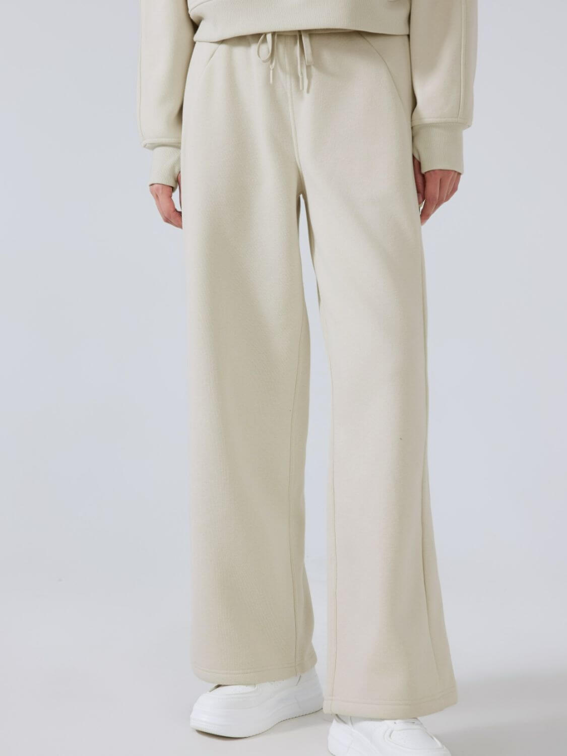 Millennia Drawstring Wide Leg Pants in beige, featuring a comfortable waist and trendy wide leg design for stylish outfits.