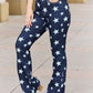 Woman wearing Janelle Full Size High Waist Star Print Flare Judy Blue Jeans with dark wash finish and high waist design for a flattering fit.