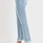 Side view of RISEN full size raw hem distressed cropped flare jeans in light wash, paired with stylish sandals.