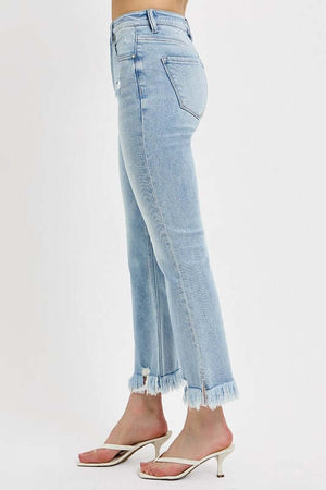 Side view of RISEN full size raw hem distressed cropped flare jeans in light wash, paired with stylish sandals.