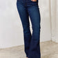 Woman wearing mid rise flare jeans, offering a timeless silhouette with a clean, non-distressed look. Slightly stretchy, super stretch denim.