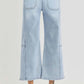 RISEN high rise wide leg crop jeans with seamed detail shown from the back, paired with white heels for a chic look.