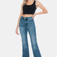 Woman wearing Judy Blue Full Size Tummy Control Vintage Wash Cut Hem Flare Jeans, showcasing a stylish and flattering look.