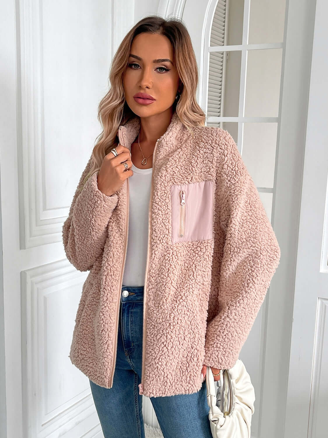 Woman wearing Ivy Lane Zip Up Long Sleeve Fuzzy Jacket in Watermelon Pink, showcasing cozy and stylish cold-weather fashion.