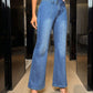 Woman models Bella Road Bootcut Jeans featuring pockets in blue denim, perfect for a stylish and comfortable look.