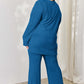 Plus-size model wearing blue ribbed high-low top and wide leg pants set, showing back view.