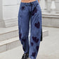 Stylish woman in Bella Road Denim Heart Mid Rise Jeans with heart design, showcasing a fun and trendy look.